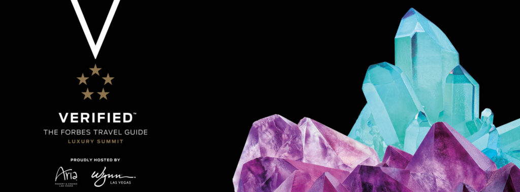 Luxurious treatment tables and spa equipment with vibrant crystals backdrop.