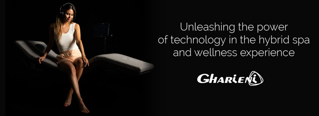 Woman on Gharieni spa treatment table with tech features in wellness setting.