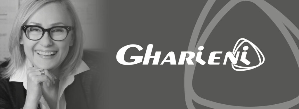 Gharieni logo with smiling individual, symbolizing premium spa treatment tables.