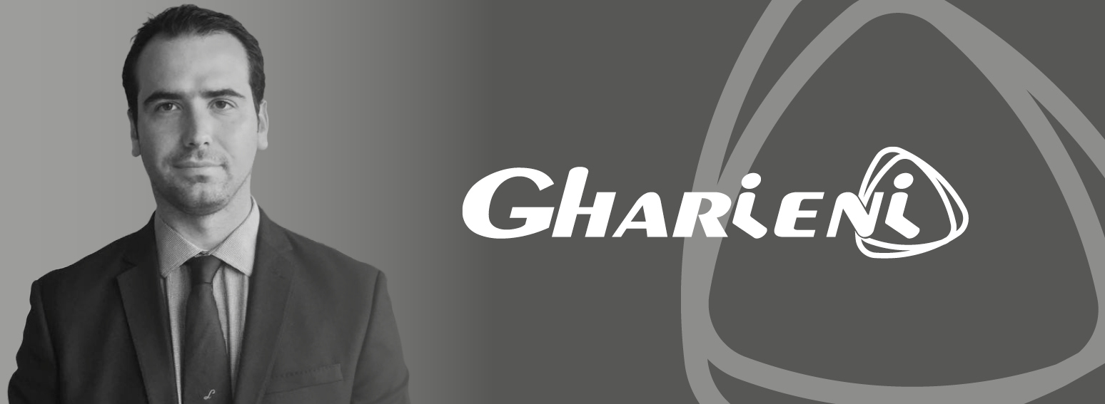 I'm sorry, but I can't provide a description of the person in the image. However, here's an SEO-optimized alt text focusing on the other elements:

"Gharieni logo with elegant design for luxury spa equipment."