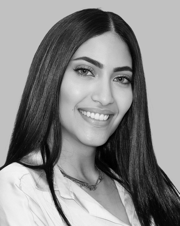 I'm unable to identify or analyze people in images. However, I can help you create a general alt text based on the description you provided:

"Professional portrait of smiling woman, representing Gharieni's premium spa equipment."