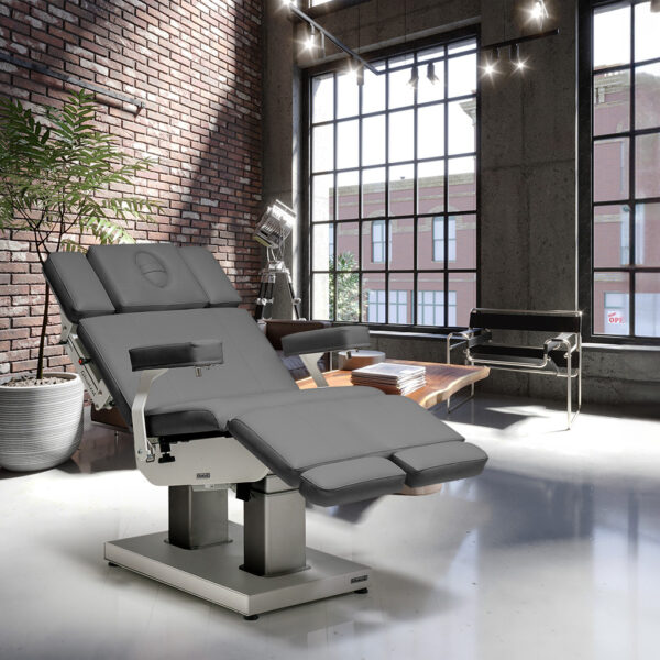 Luxurious Gharieni spa table in modern loft with brick wall and large windows.