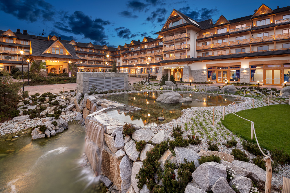 Luxurious spa resort with elegant architecture and serene water features at dusk.