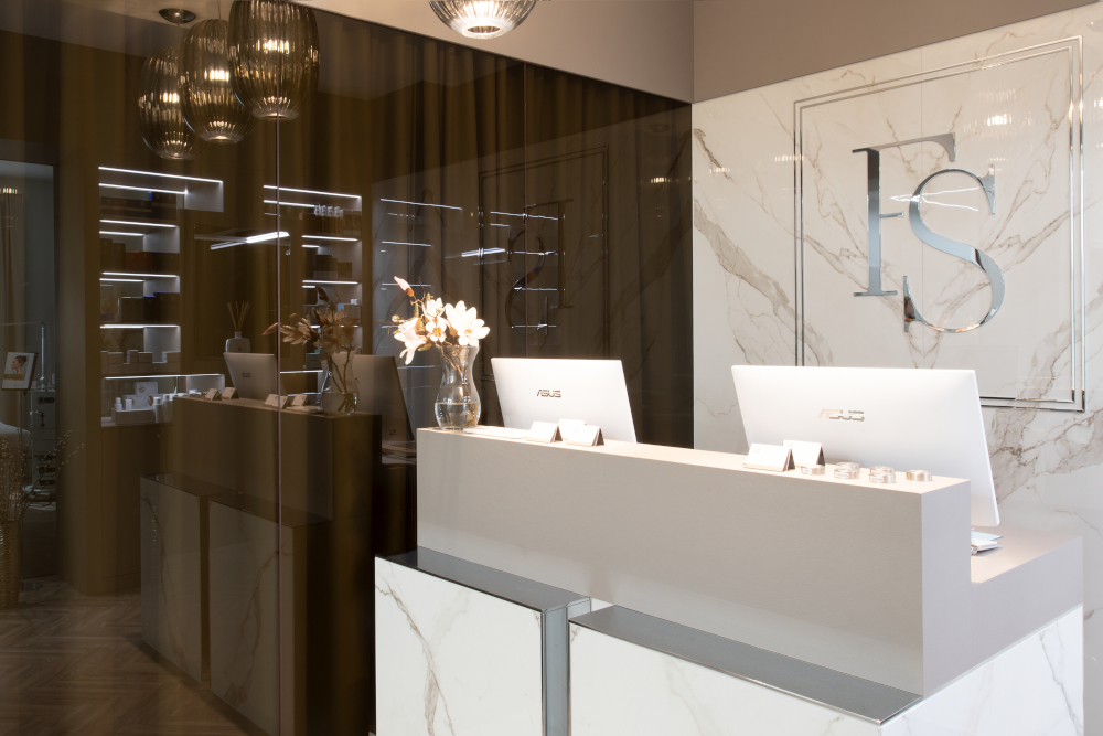 Modern spa reception with marble decor, sleek treatment tables, and elegant lighting.