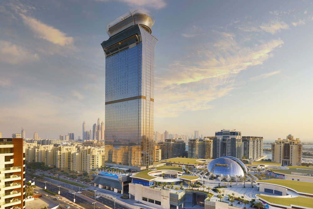 Luxurious high-rise building at sunset, skyline view, elegant modern architecture.