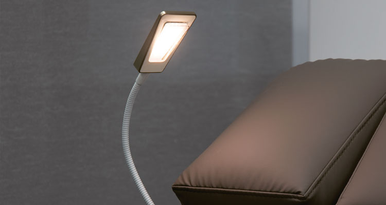 Luxurious spa treatment table with adjustable LED reading light.