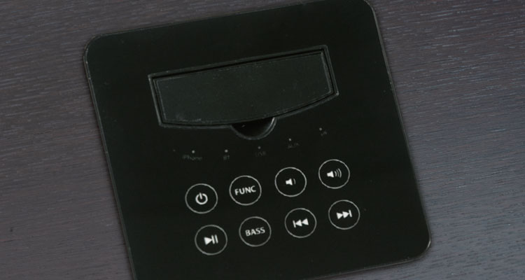 Control panel on luxury spa equipment by Gharieni, featuring bass and function buttons.