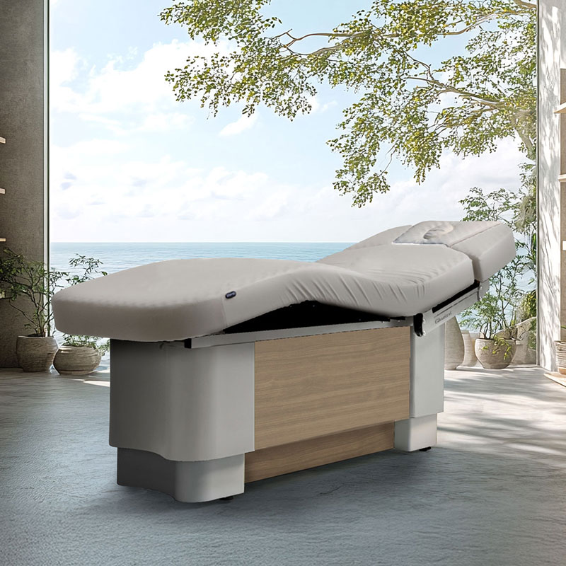 Luxurious Gharieni spa treatment table in serene coastal setting.