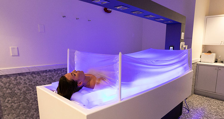 Luxurious spa treatment on Gharieni premium table with ambient lighting.