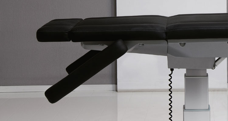 Gharieni premium treatment table with adjustable features in modern spa setting.