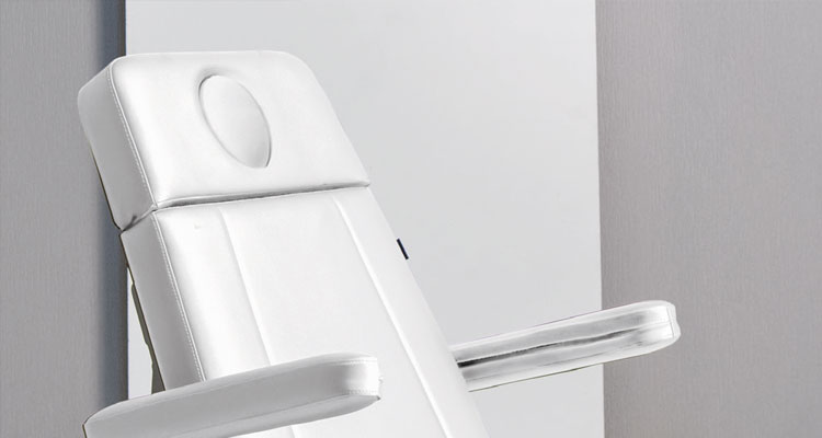 Luxurious white spa treatment table with adjustable headrest, Gharieni.