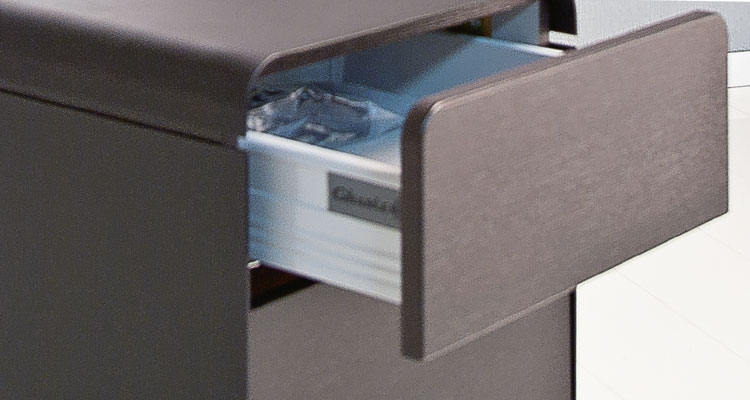 Open drawer of luxury spa treatment table by Gharieni, showcasing sleek design.