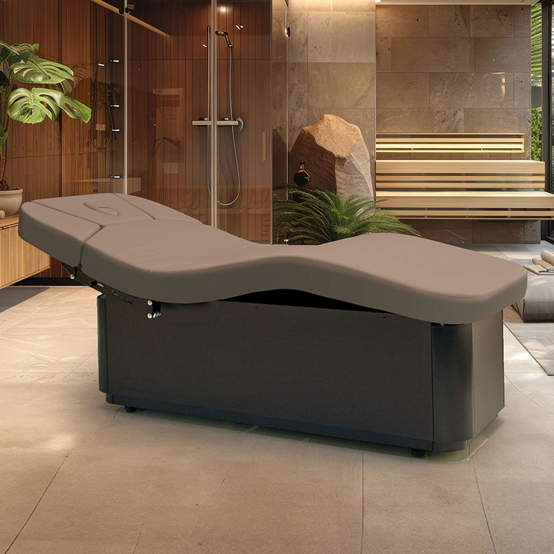 Luxurious Gharieni treatment table in an elegant spa setting with wood accents.