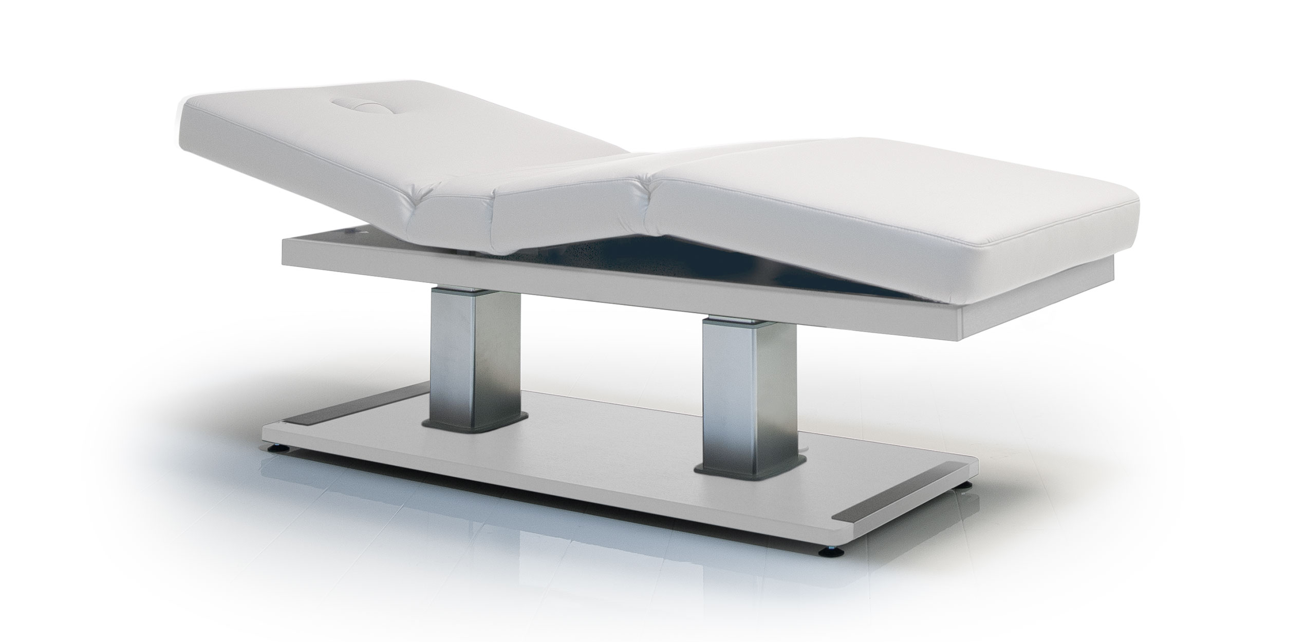 Luxurious white spa treatment table with adjustable design for premium comfort.