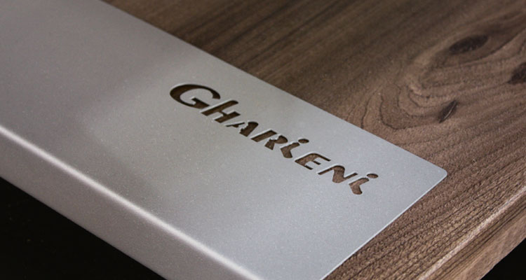 Alt-Text: "Gharieni luxury treatment table with premium wood finish."