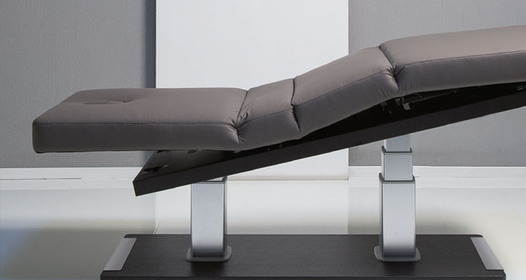 Luxurious Gharieni spa treatment table with sleek, modern design.