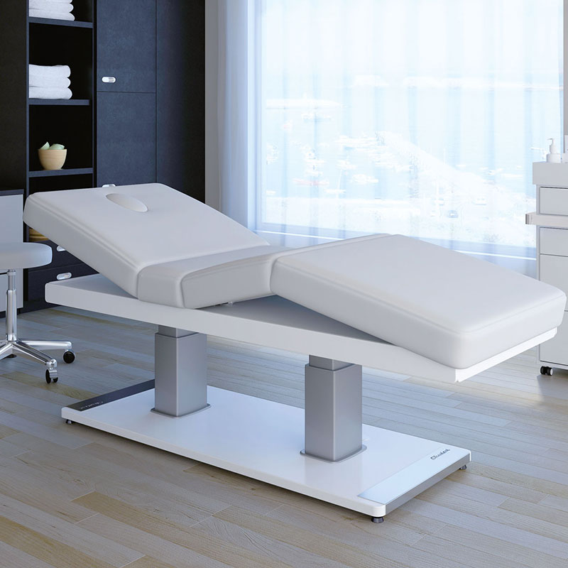 Luxurious Gharieni treatment table in modern spa setting with ocean view.