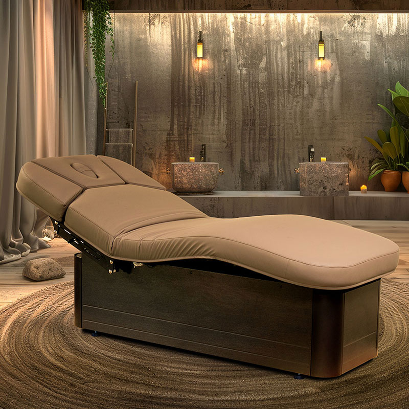 Luxurious spa room with premium Gharieni treatment table, ambient lighting.