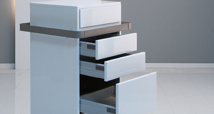 Gharieni spa equipment: sleek, modern treatment table drawers open in a minimalist design.