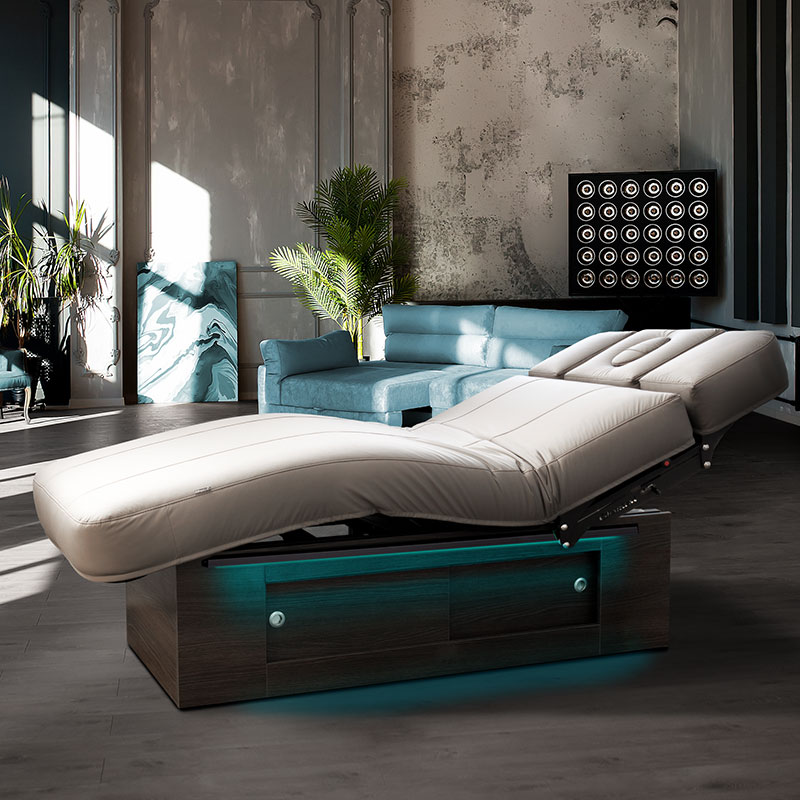 Luxurious Gharieni spa treatment table in modern, elegant therapy room.