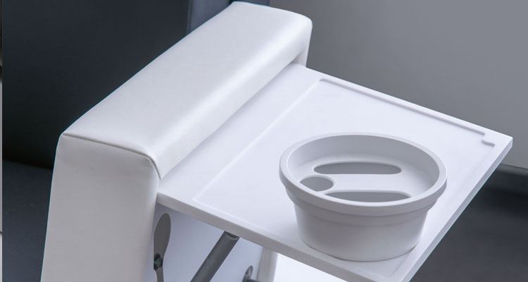Luxurious spa treatment table with a sleek design and integrated bowl.