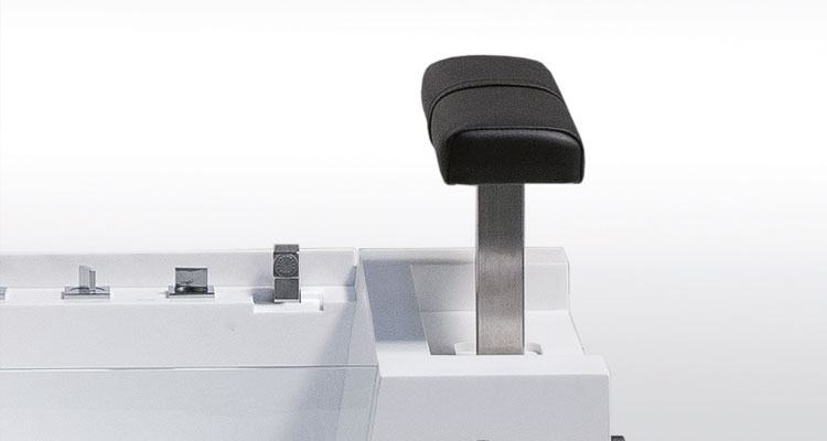 Luxurious Gharieni spa treatment table with adjustable headrest and sleek design.