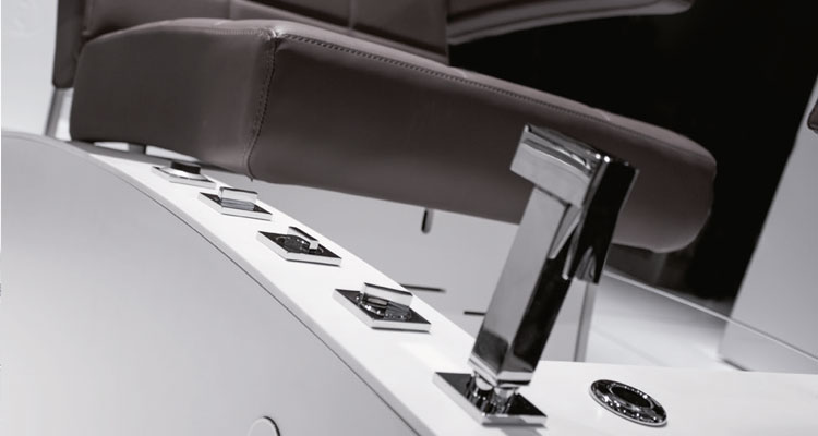 Luxurious Gharieni spa treatment table with sleek design and modern controls.