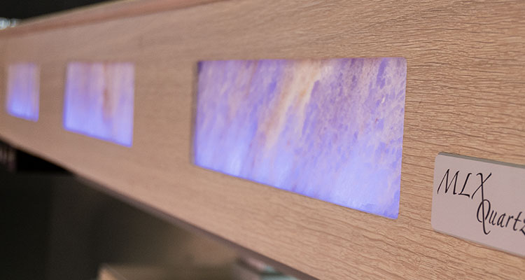 "Luxury Gharieni MLX Quartz spa table with glowing amethyst panels."