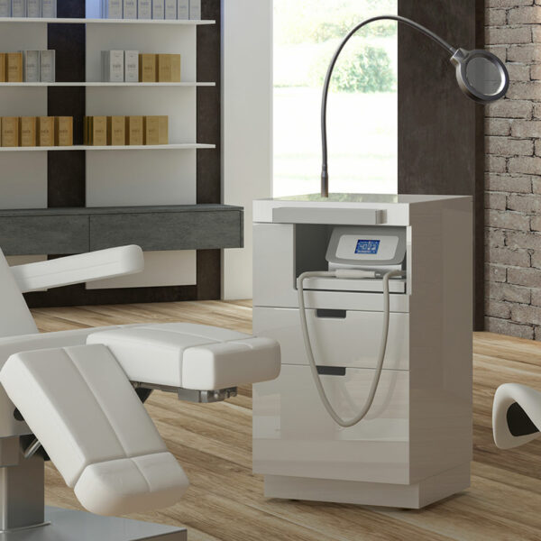 White luxury spa treatment table and modern equipment in elegant wellness room.