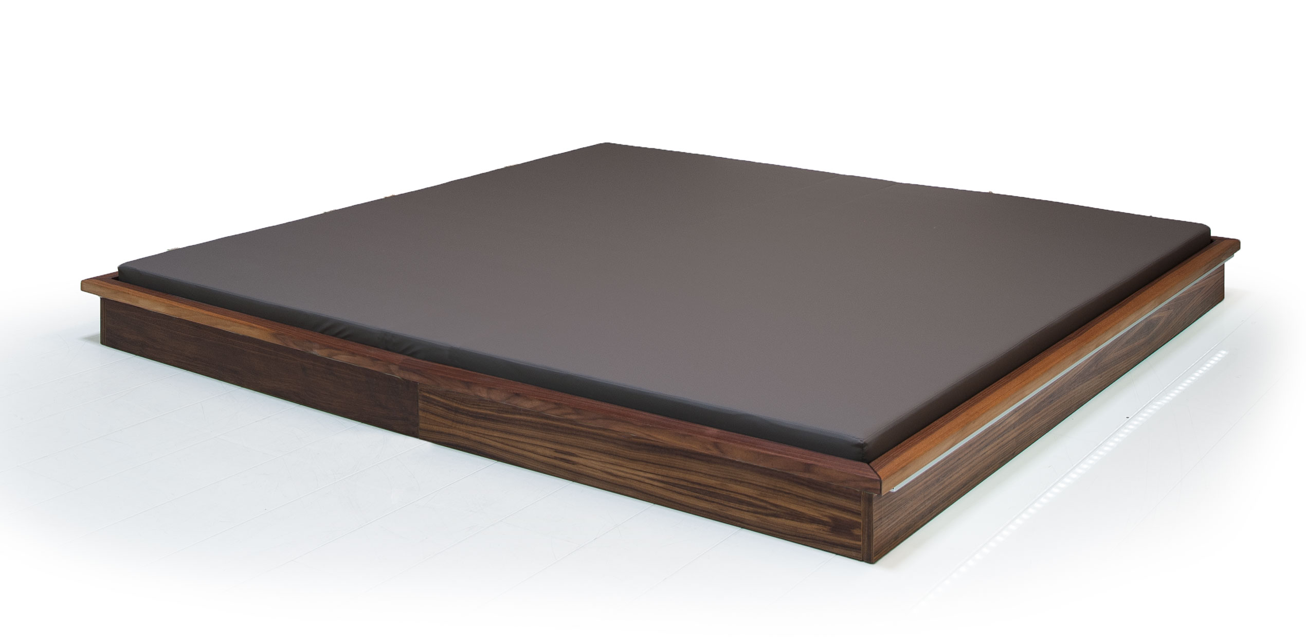 Luxurious Gharieni treatment table with sleek design and premium wood finish.