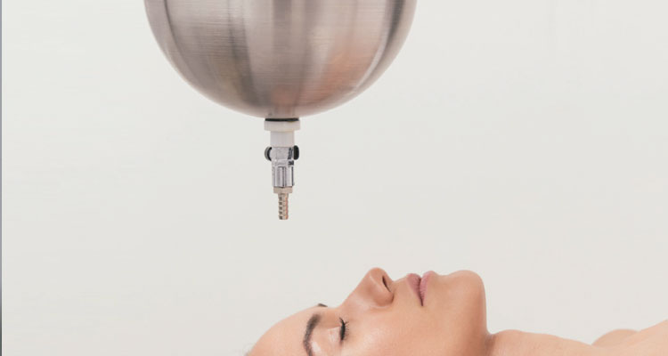 I'm unable to analyze the content of the image, but I can help craft an SEO-optimized alt text based on the provided context and description:

"Luxury spa table with advanced treatment equipment from Gharieni."
