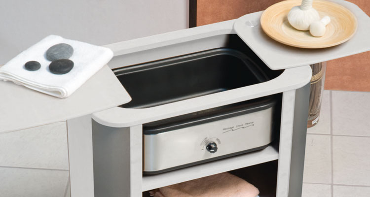 Modern spa equipment with sleek design, featuring hot stone and towel storage.