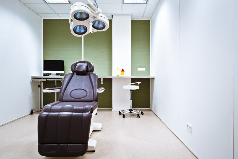Luxurious Gharieni spa treatment table in modern, well-equipped therapy room.