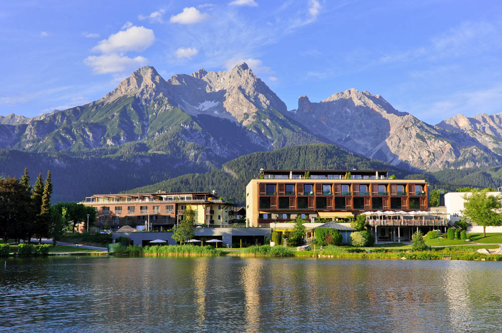 Luxurious spa resort with mountain view and serene lake setting.
