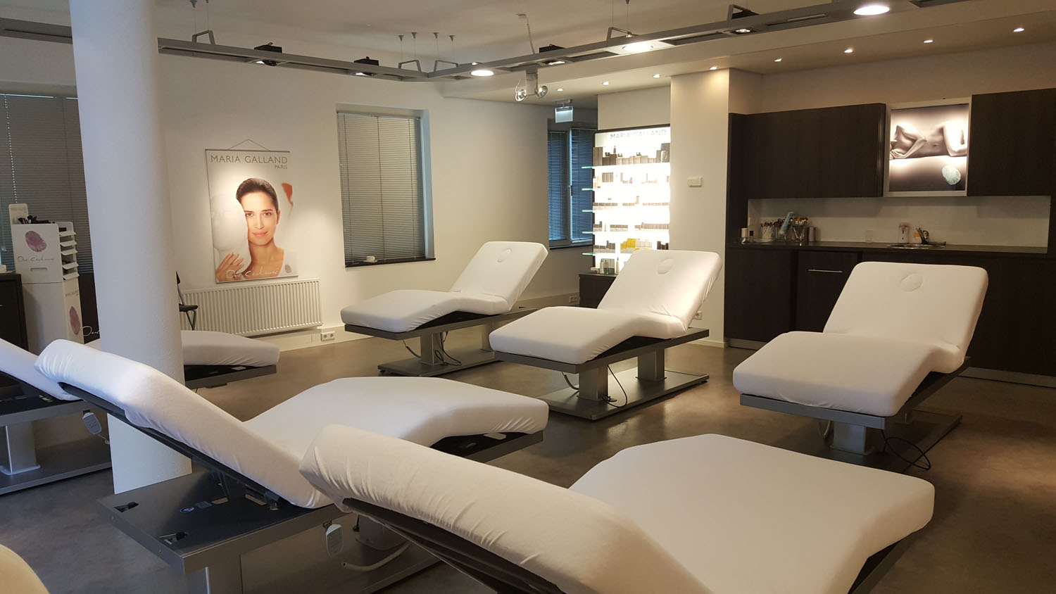 Luxurious spa treatment room with premium Gharieni massage tables.