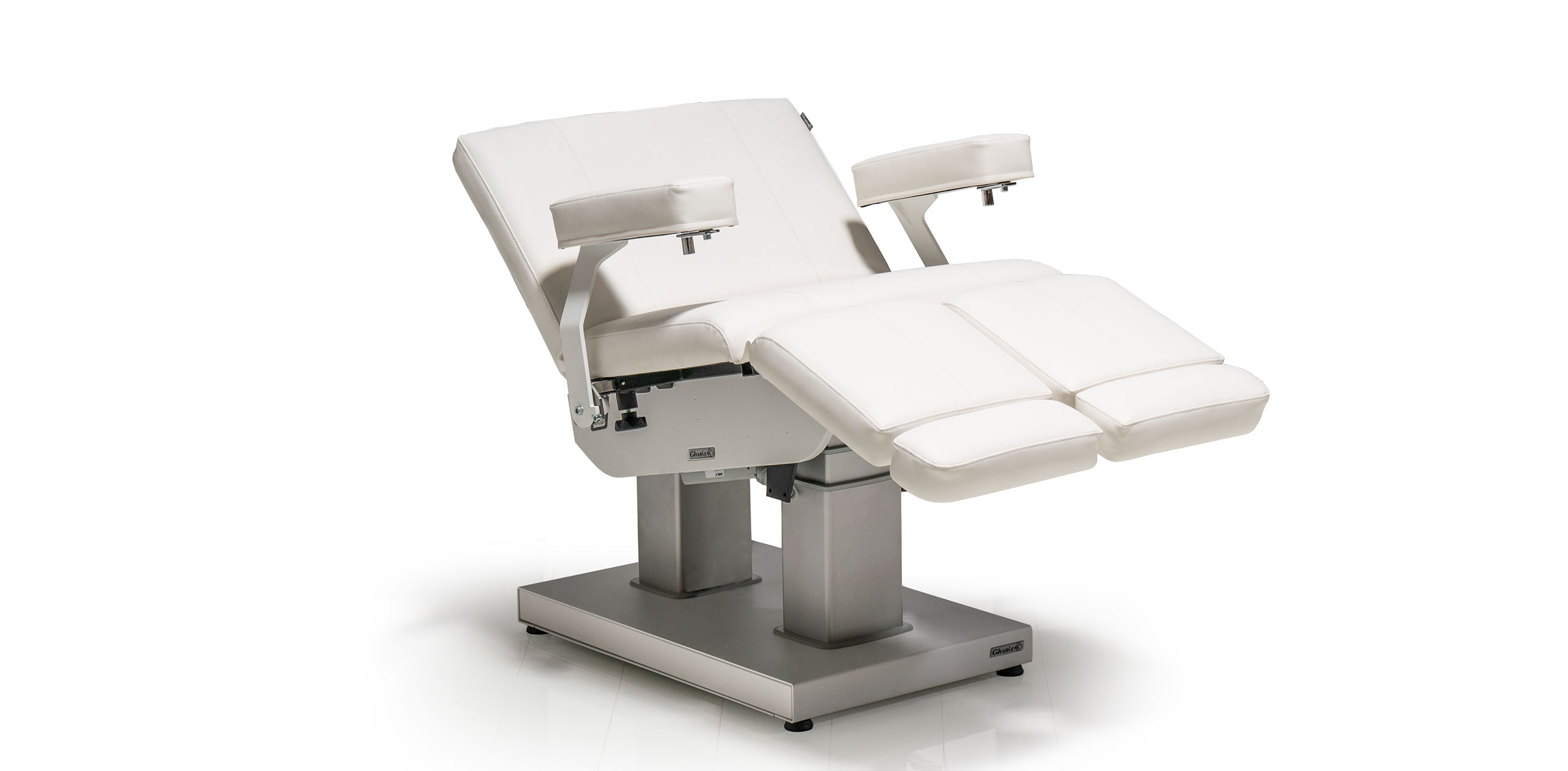 Luxurious Gharieni spa treatment table in sleek white design for premium wellness.