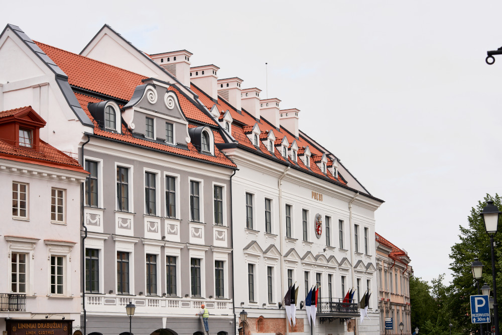 Elegant historic building with red roof, European architecture, city street view.
