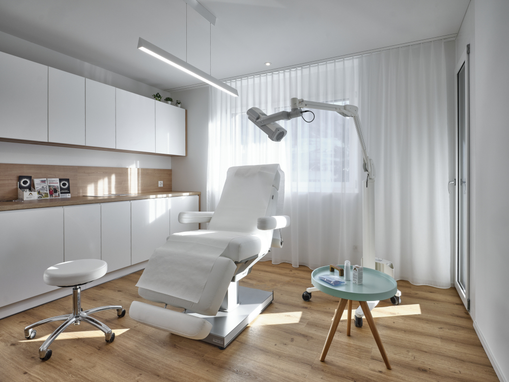 Modern spa treatment room with premium Gharieni treatment table and equipment.