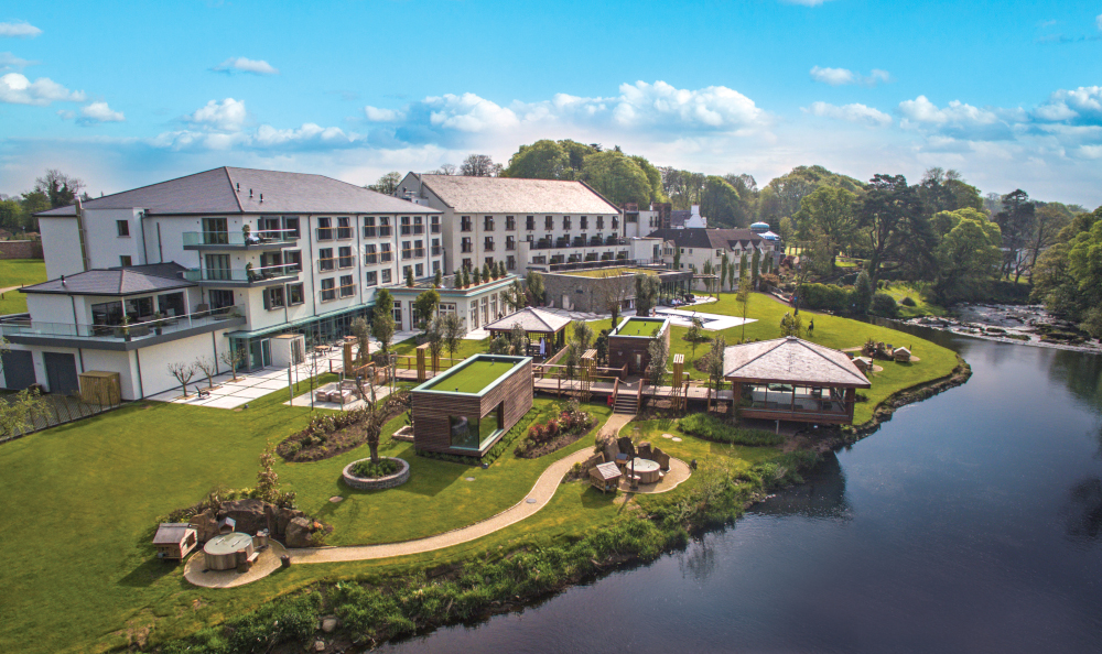 Luxurious riverside spa resort with premium treatment areas and lush gardens.