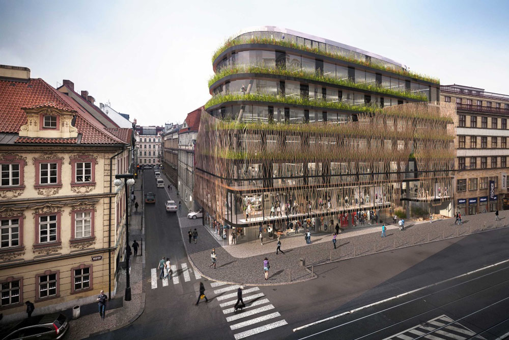Modern architectural building with green façade and urban street view.