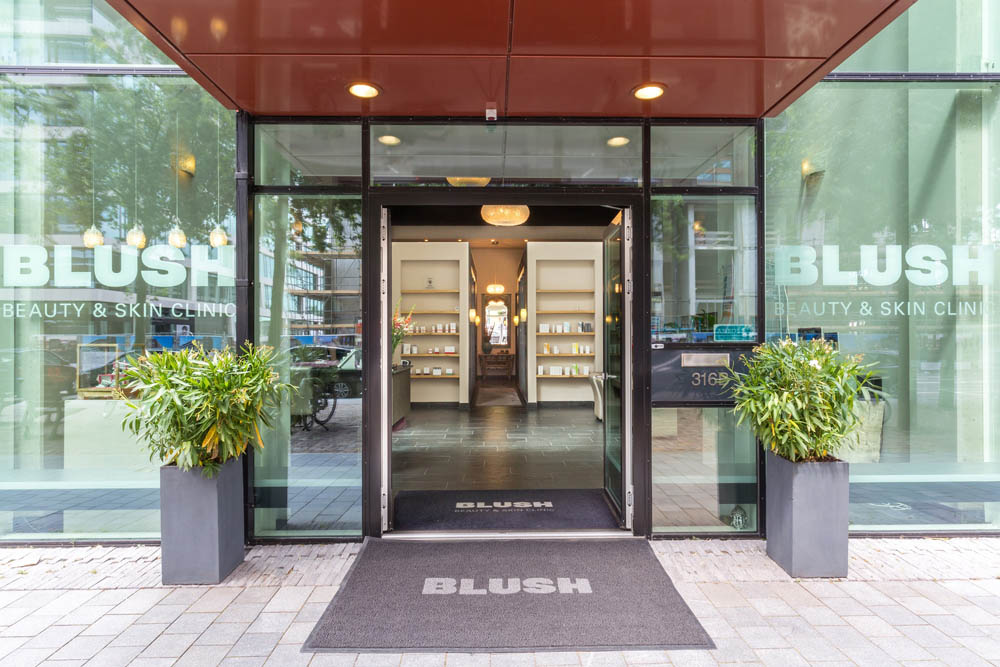 Entrance to Blush Beauty & Skin Clinic with modern decor and greenery.