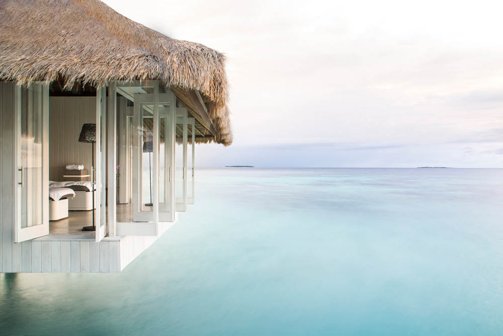 Luxury spa treatment room overlooking serene ocean view.