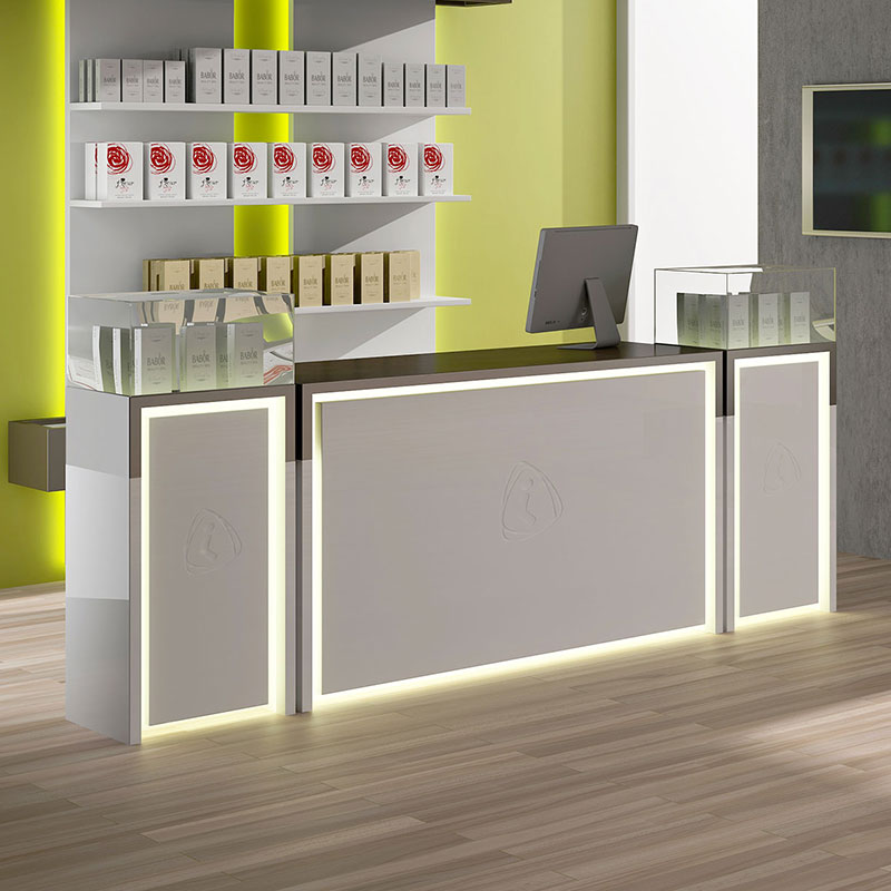 Modern spa reception with illuminated desk and premium product display.