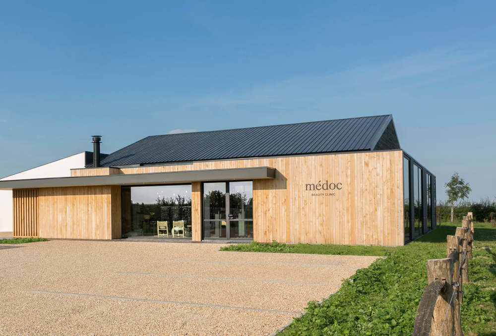 Modern spa exterior with wooden facade, showcasing Gharieni's premium treatment tables.