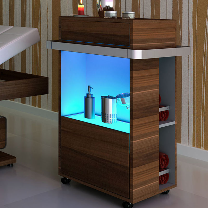 Luxurious spa treatment table with modern wooden design and ambient lighting.