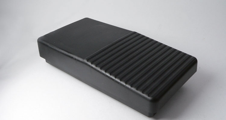 Sleek black Gharieni treatment table accessory with ribbed texture for spa luxury.