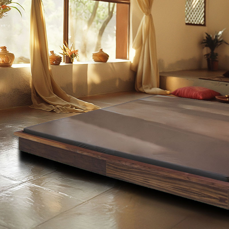 Luxurious spa treatment table in serene, sunlit room with elegant decor.