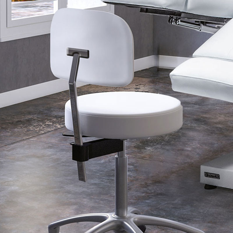 Luxurious spa chair and treatment table in a modern Gharieni spa setting.
