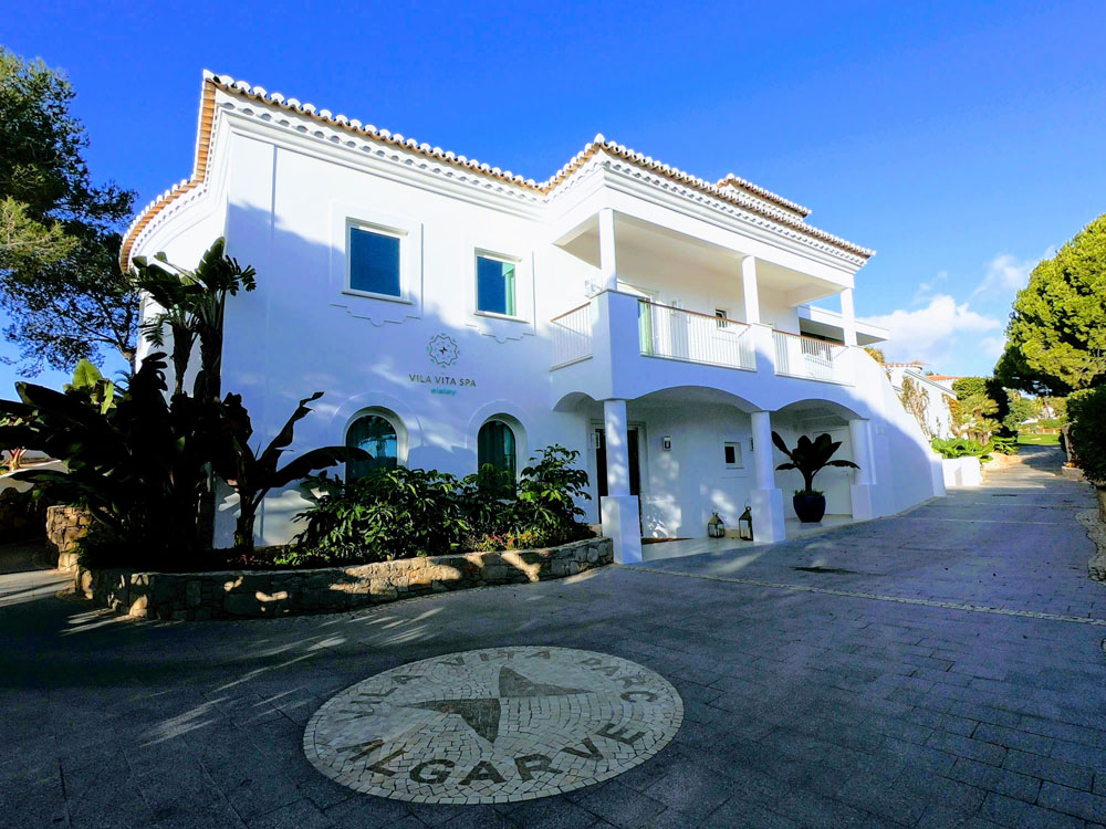Luxurious spa exterior with elegant architecture and lush greenery.