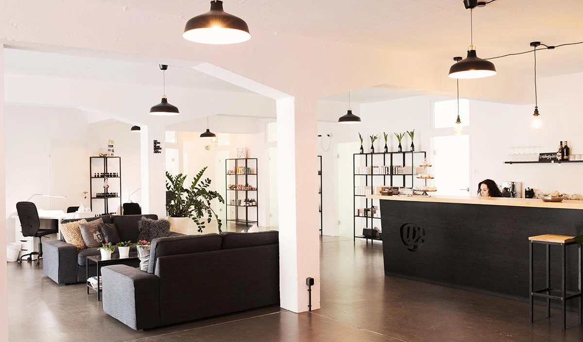 Modern spa lobby with sleek treatment tables, elegant lighting, and stylish decor.